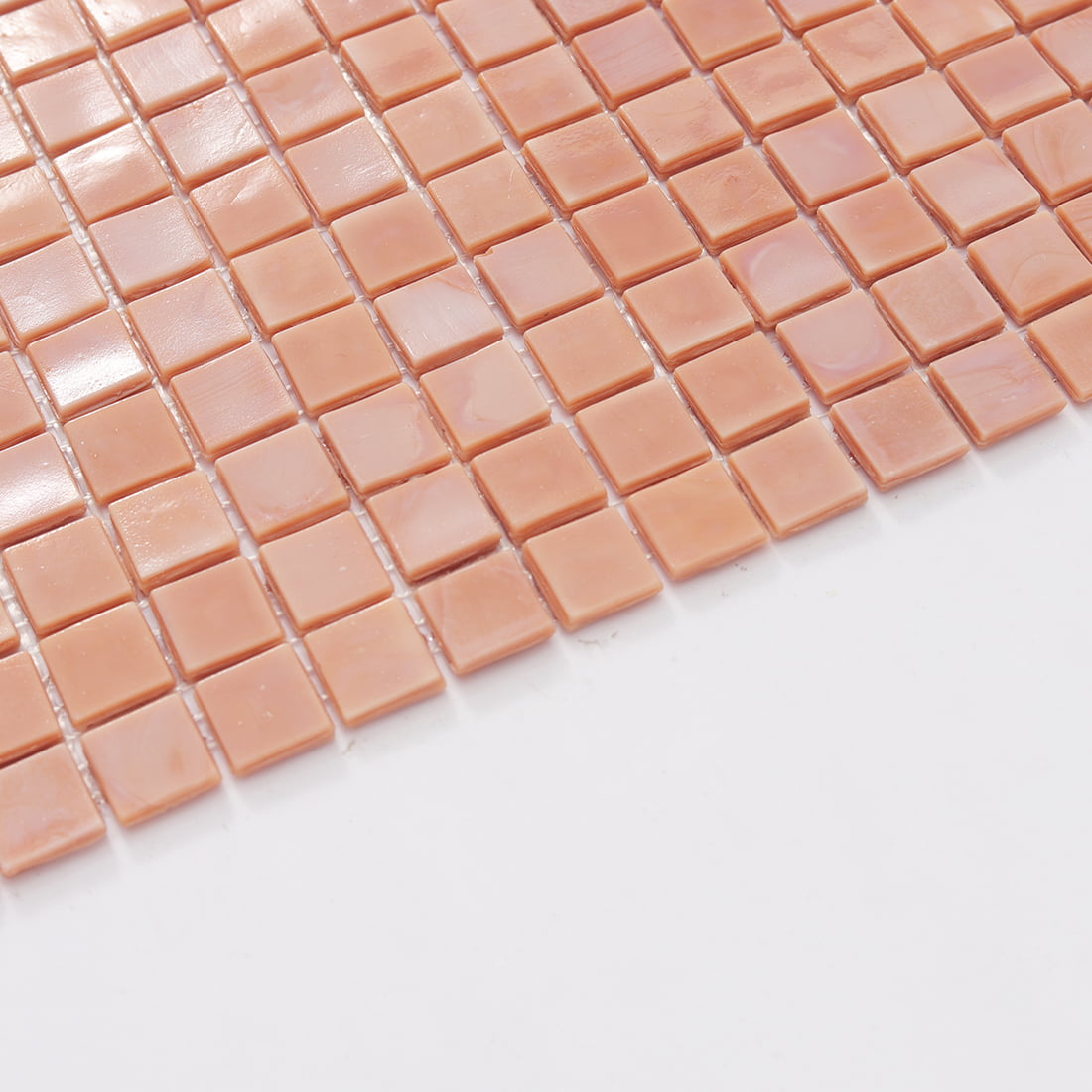 Edge detail of soft pink square glass mosaic tile