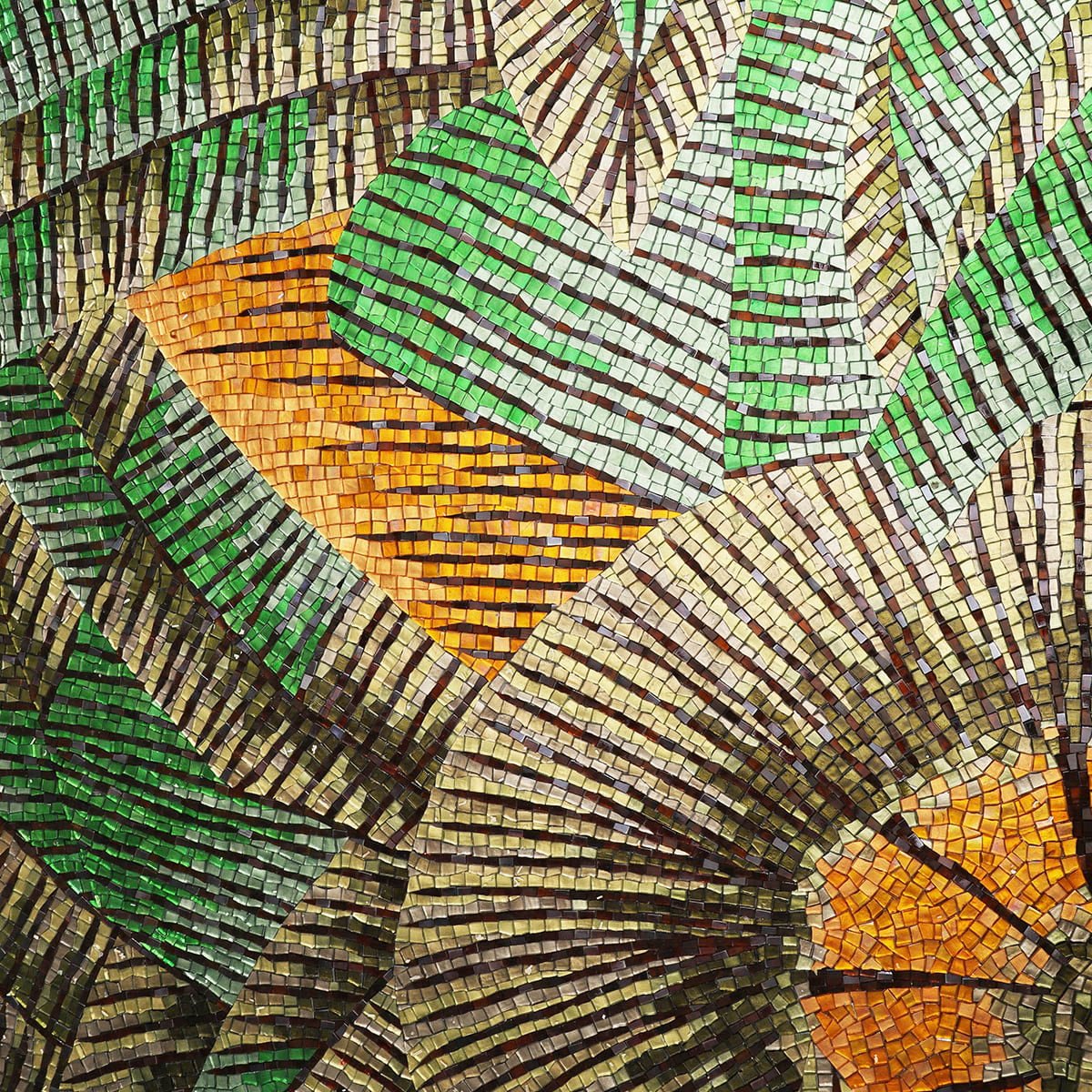 Close-up of green and gold mosaic leaves with radiant orange accent
