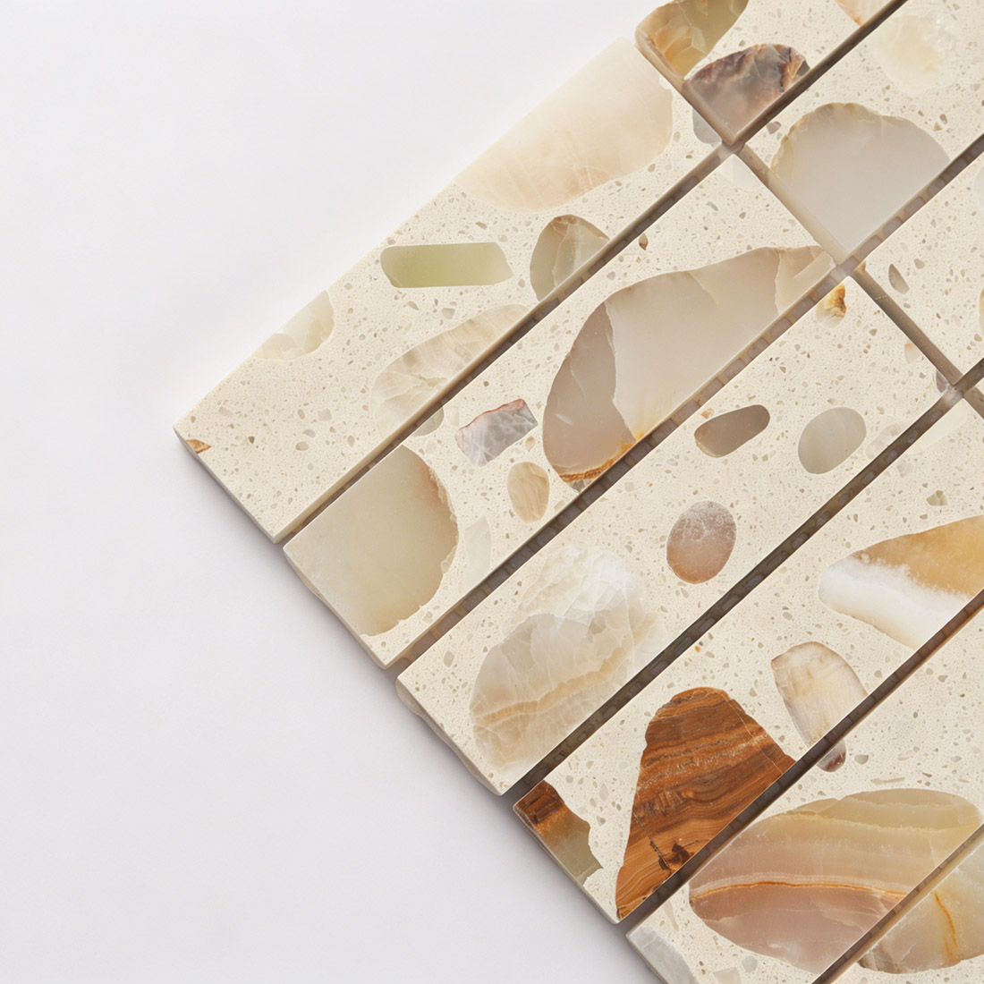 Close-up of polished surface showing stone fragments in cream terrazzo.