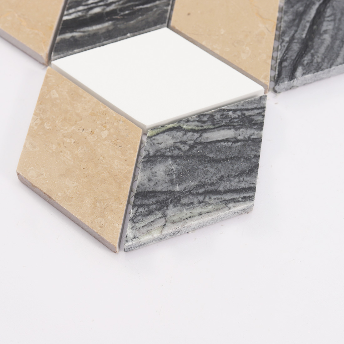 Close-up of the bottom chips of 3D cube marble mosaic.