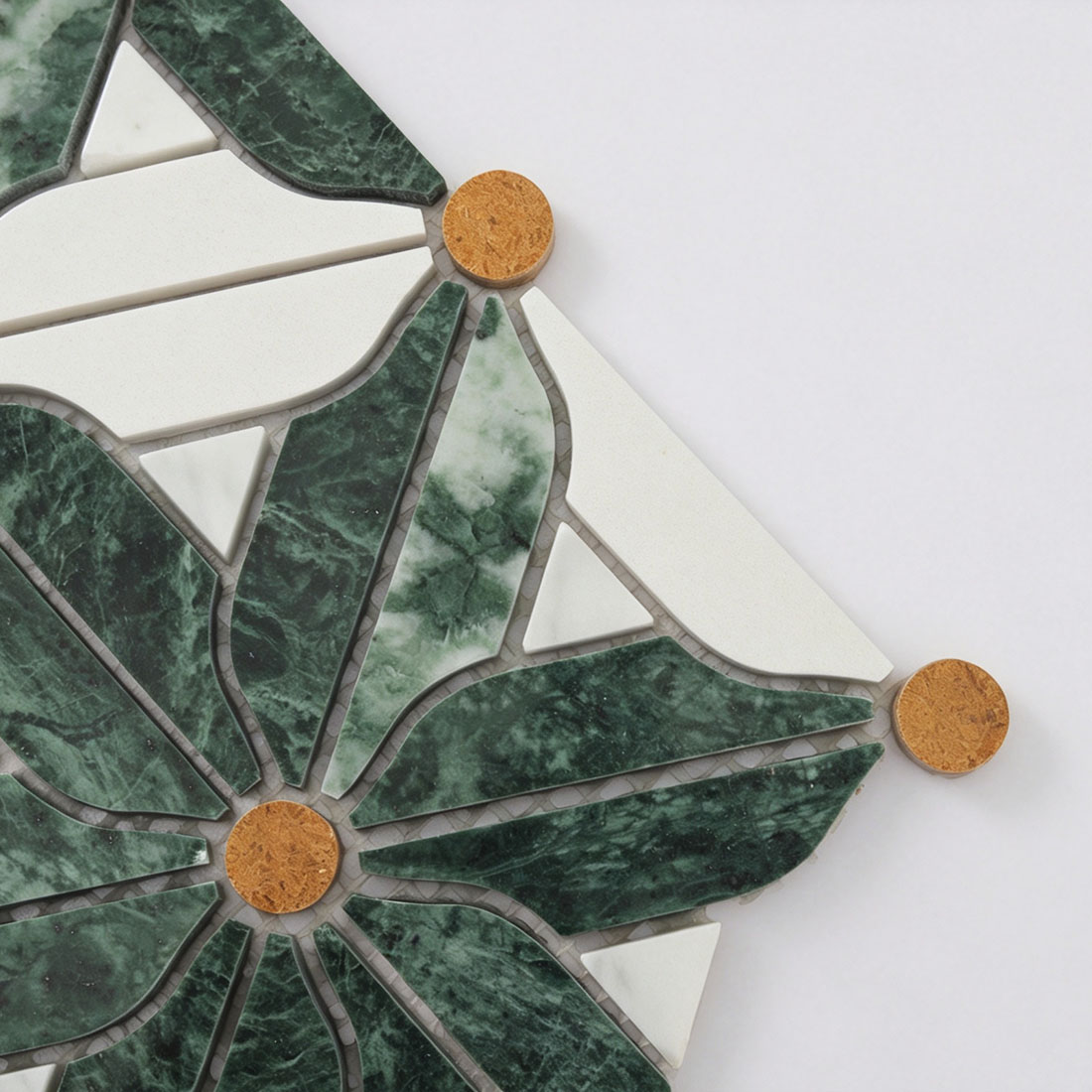 Detail of Verde Guatemala marble leaves, ivory petals, and ochre round inlays