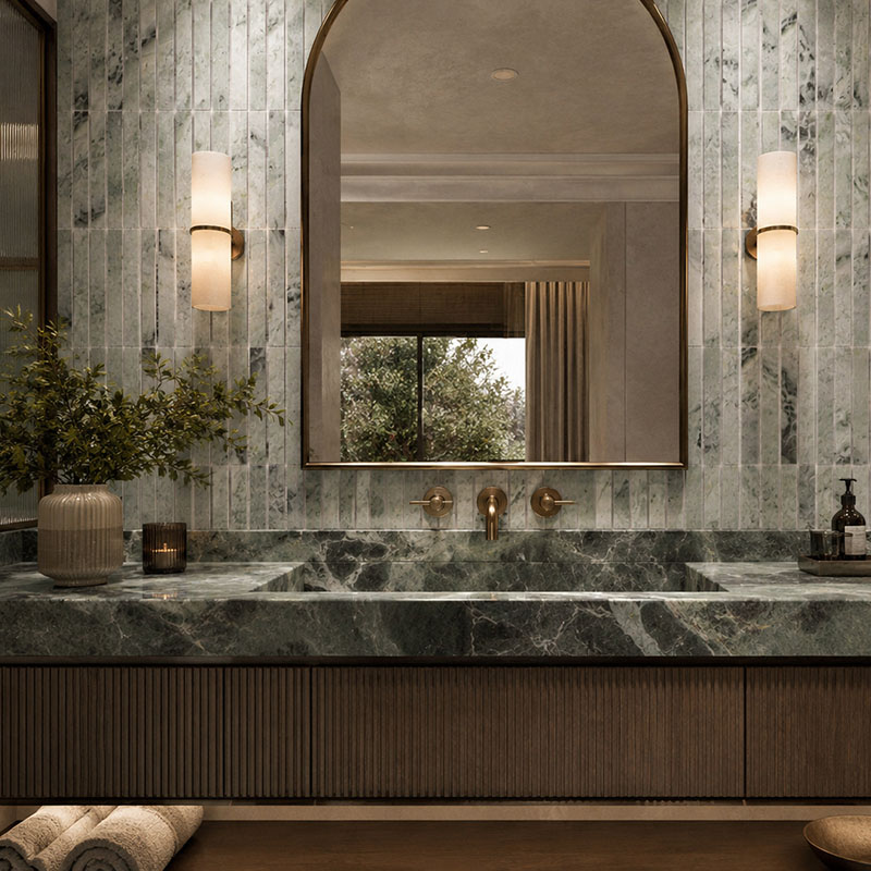 Vertical green marble wall tiles behind a modern bathroom vanity