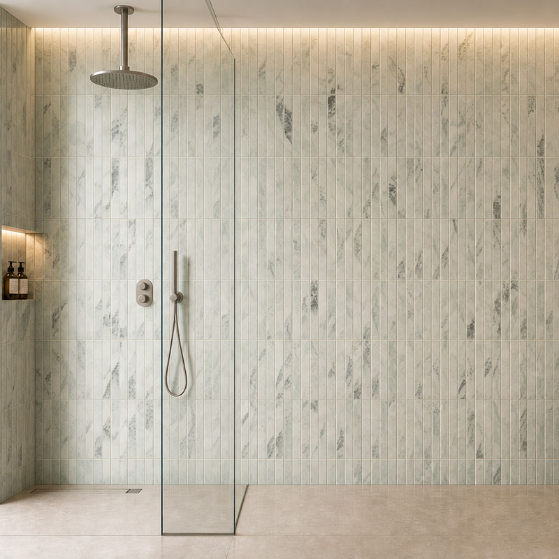Close up of vertical marble bathroom tiles with soft veining on a shower wall