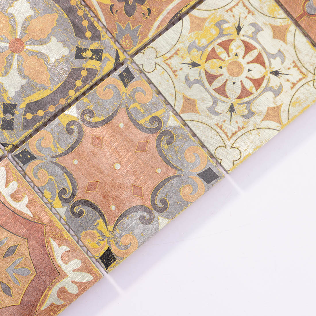 Angle shot of vintage copper patterned square aluminum mosaic tile showing edge