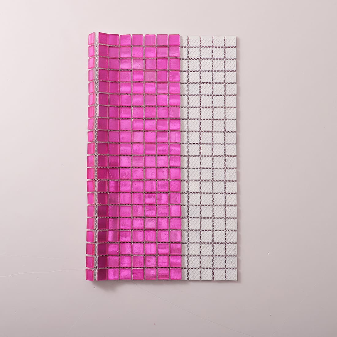 Mesh backing view of vivid pink foil-backed glass mosaic tile sheet