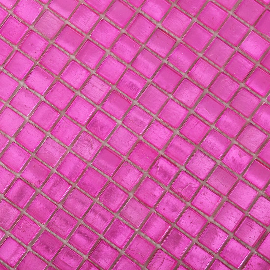 Angled close-up of vivid pink foil-backed square glass mosaic