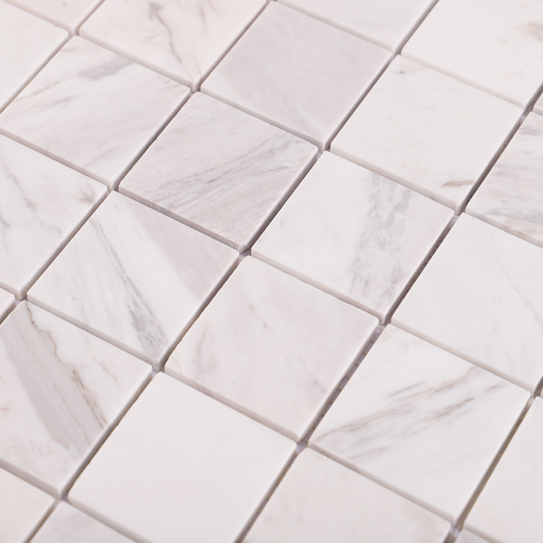 Close up of Volakas white square marble mosaic with natural veining