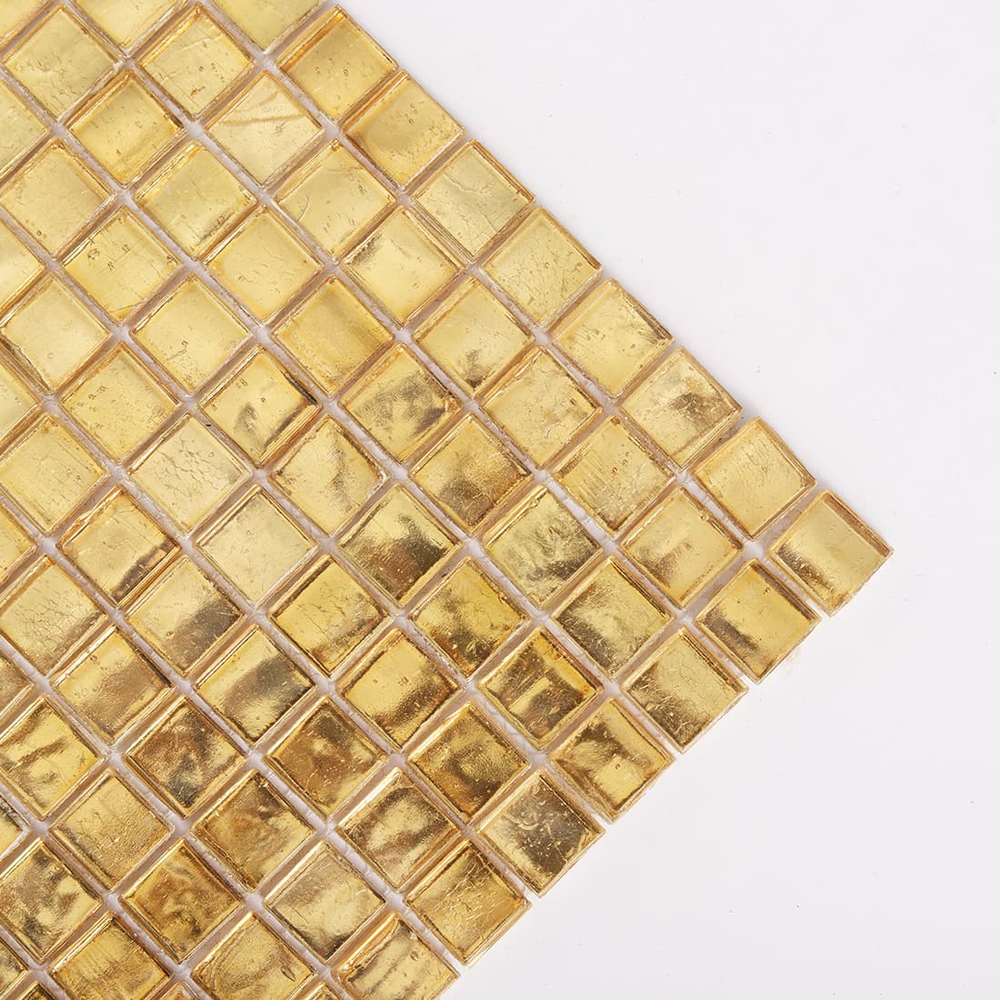 Corner close up of warm gold square glass mosaic tile sheet