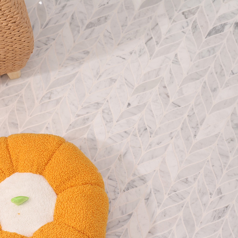 Close-up of waterjet cut Carrara marble mosaic in a delicate petal leaf pattern.