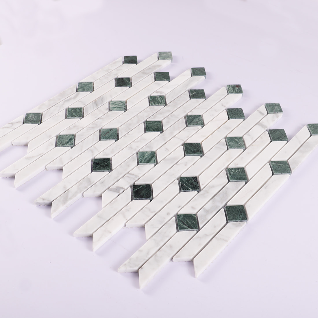 Angled display of white and green marble linear mosaic tile sheet