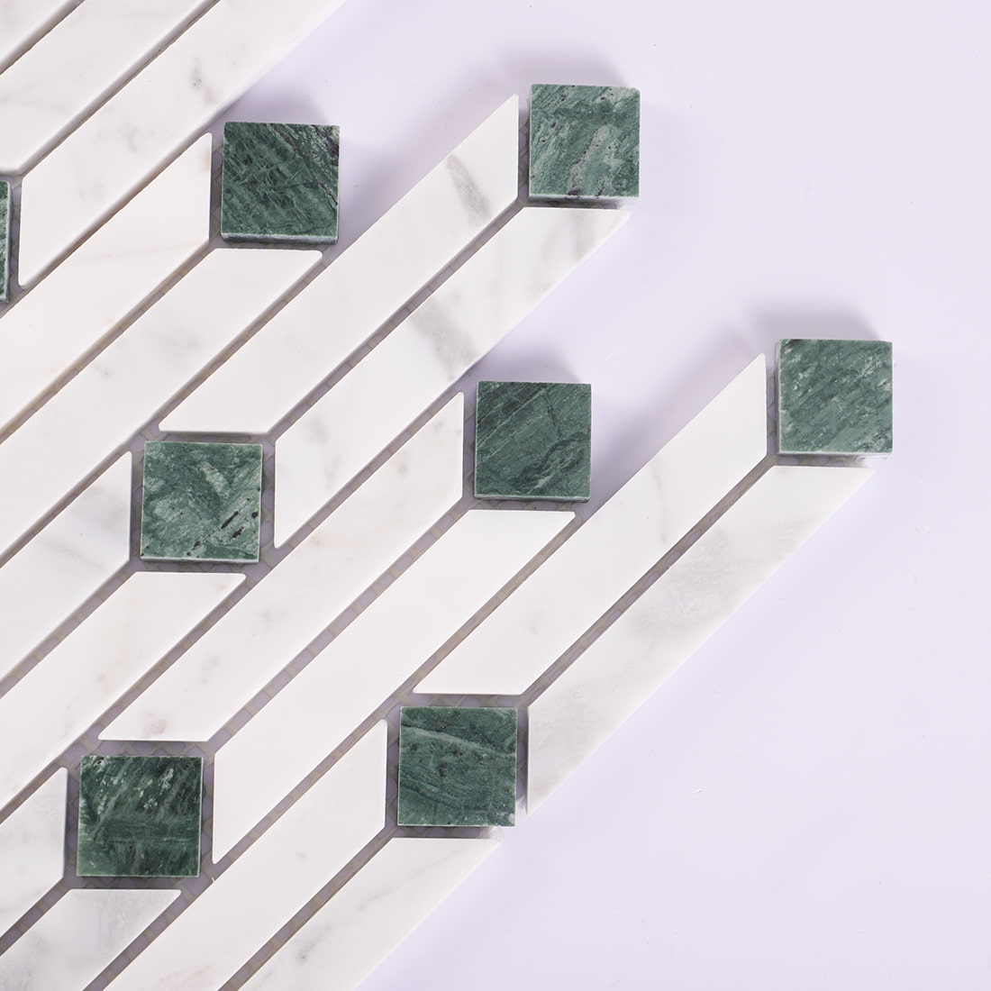 Corner detail of white and green marble linear mosaic tile