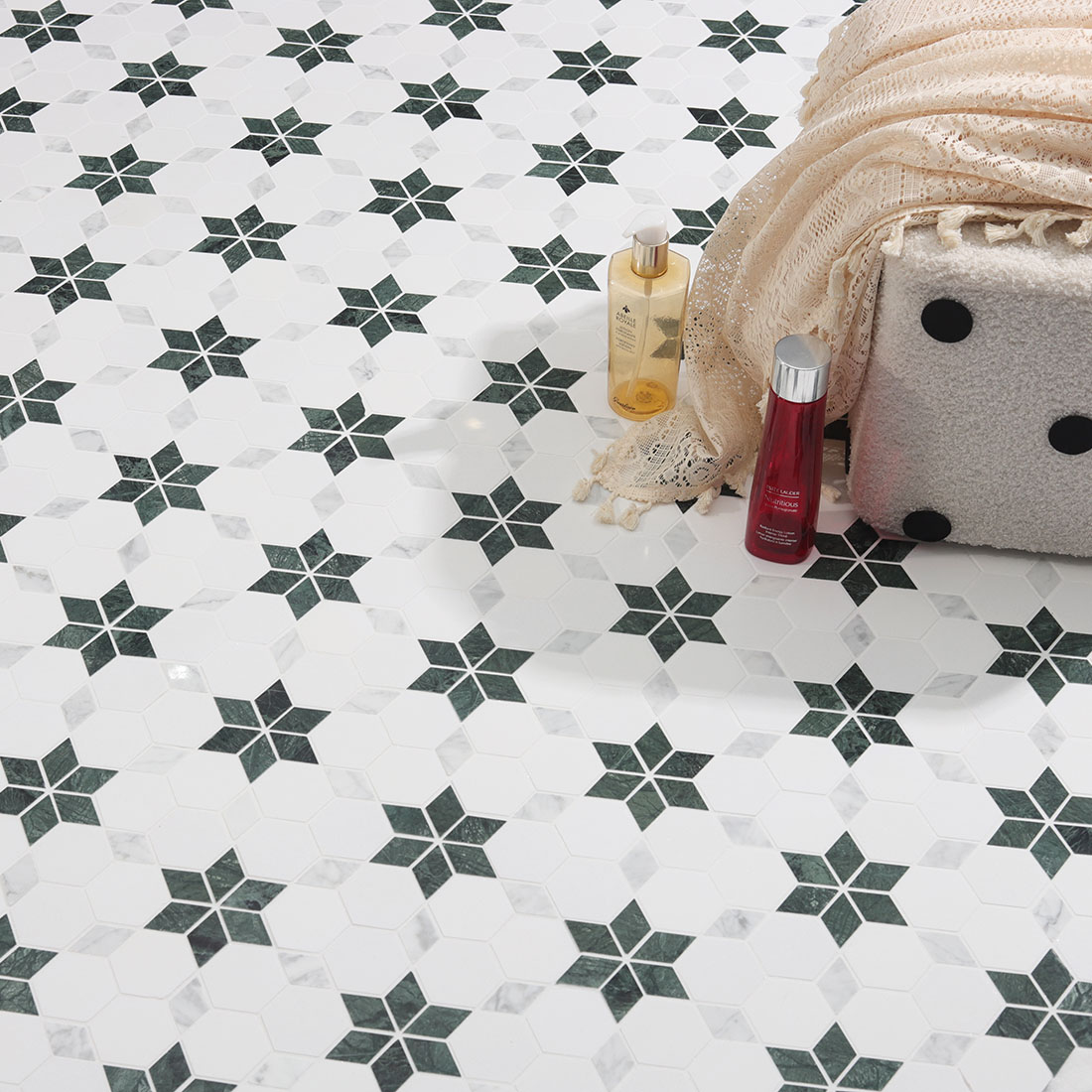 The repeating green star pattern of the water-jet marble mosaic floor.
