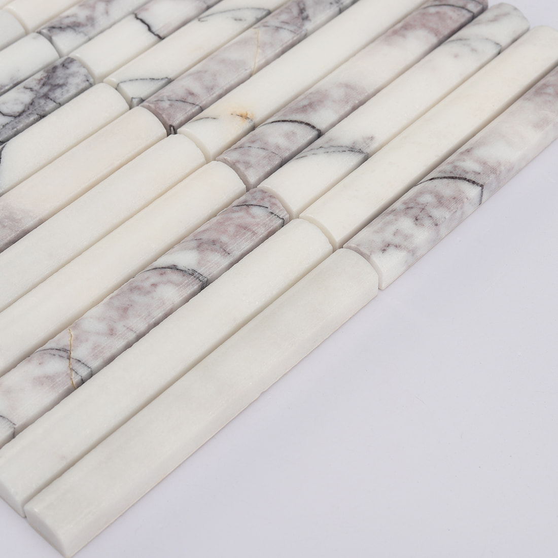 Angled edge view of white and lilac marble finger mosaic tile
