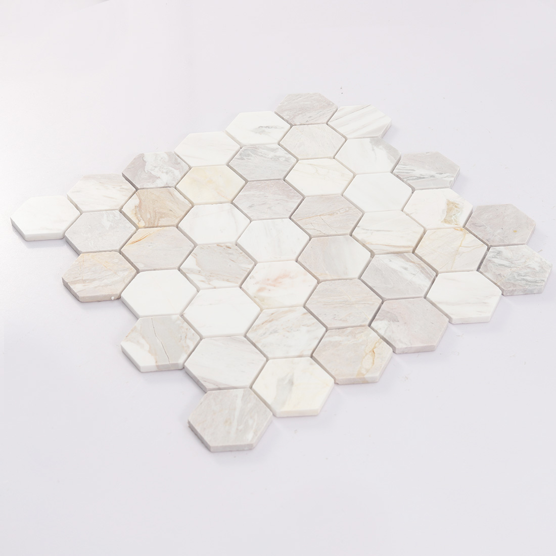 Angled sheet view of white beige hexagon marble mosaic with natural stone tones