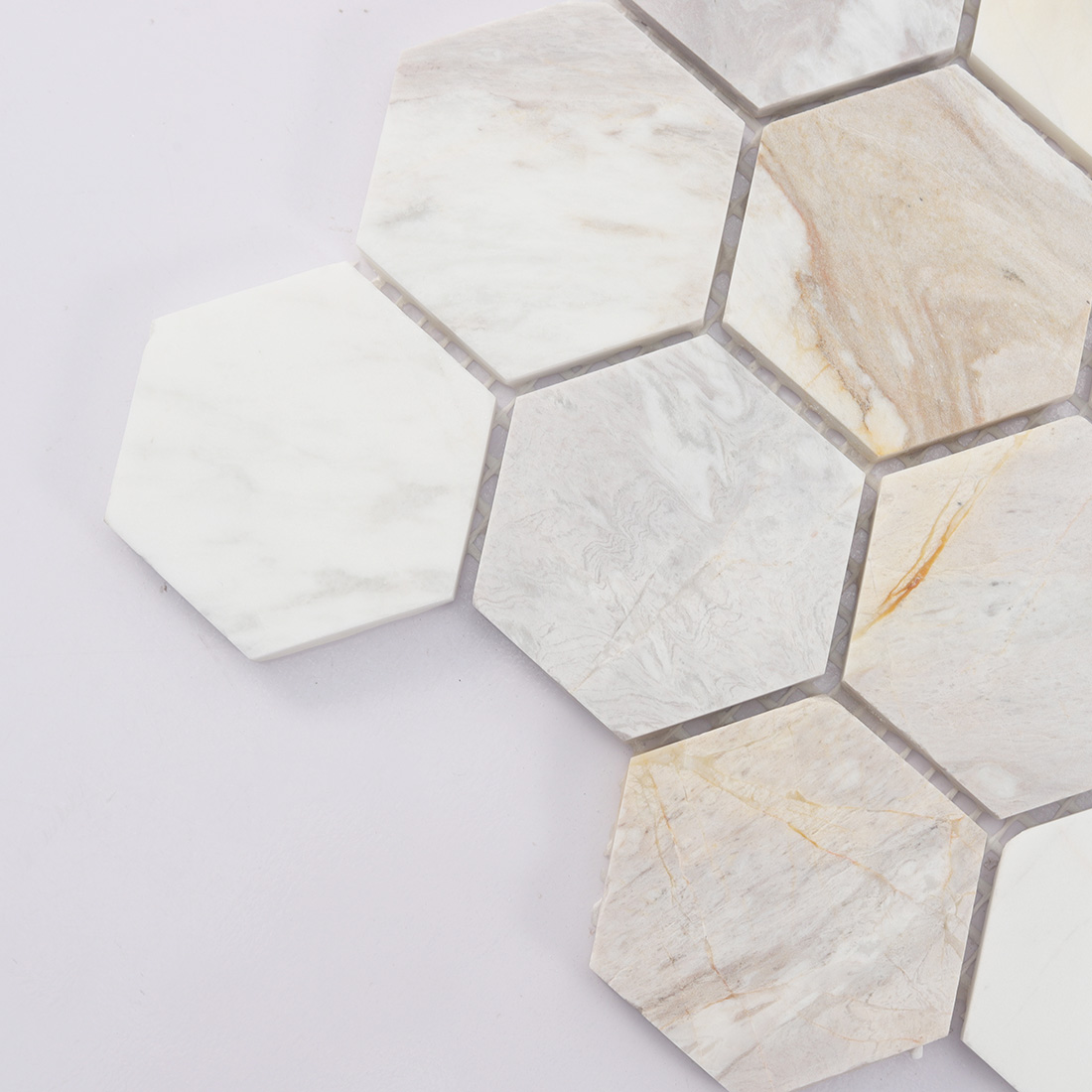Close up of white beige hexagon marble mosaic edge with natural gray veining