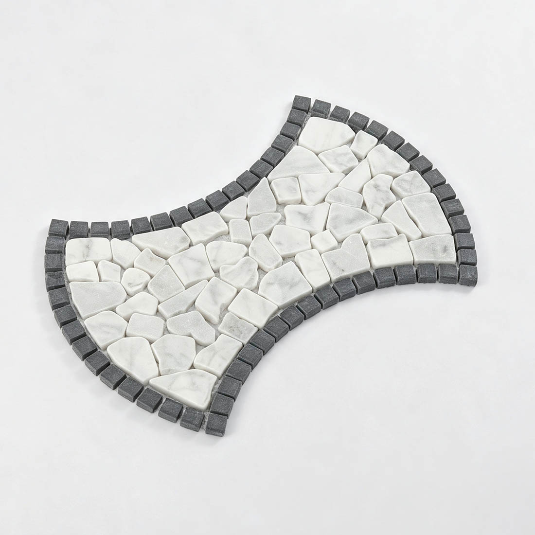 Angled display of white and black curved marble pebble mosaic