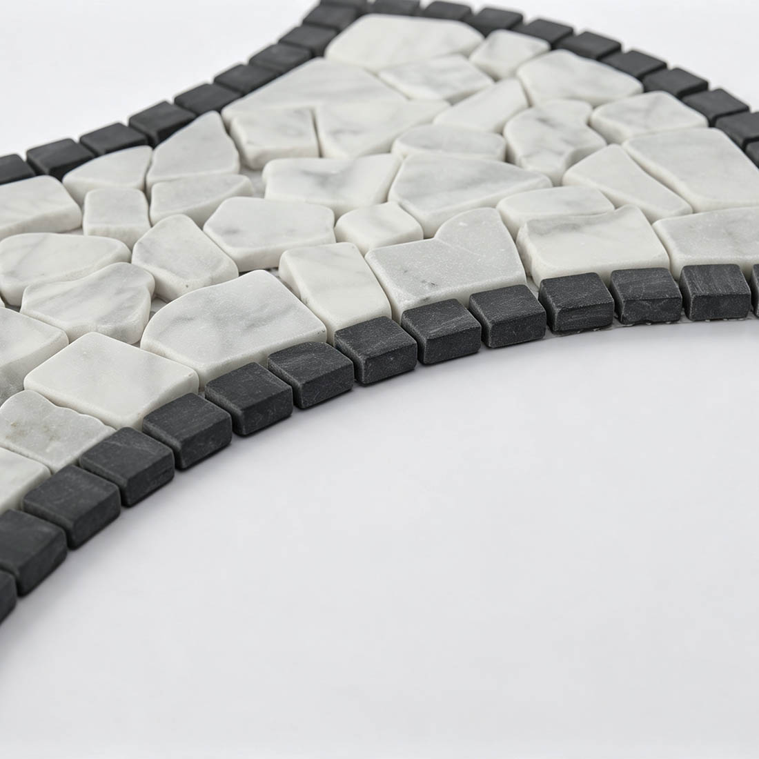 Edge view of white and black framed marble pebble mosaic
