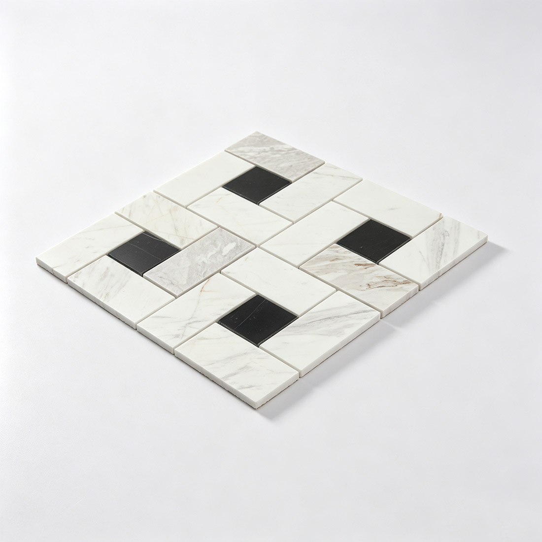 Angled view of white and black marble geometric mosaic tile sheet on a white background