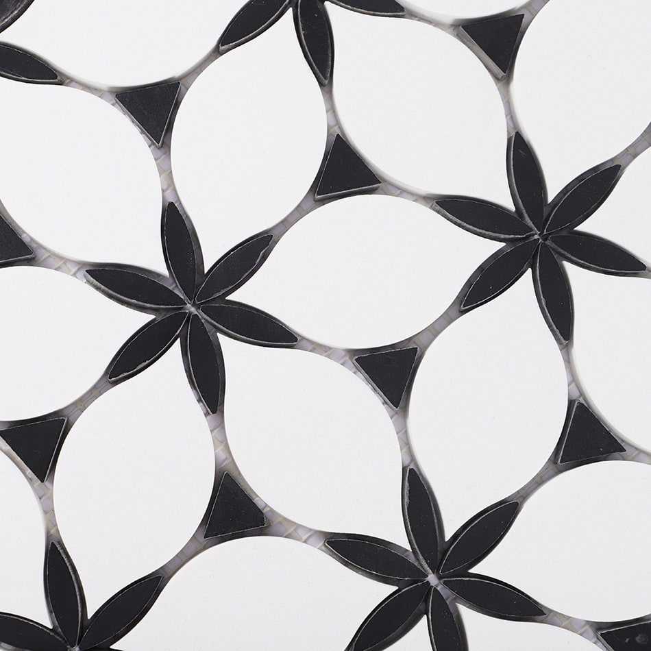 Close up of white and black marble mosaic tile with petal and flower pattern