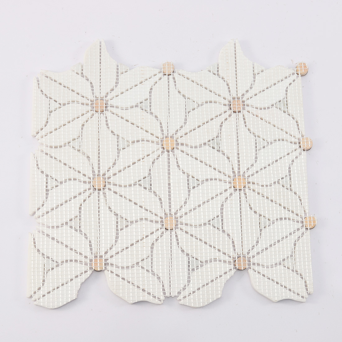 Back view showing mesh backing of white flower marble mosaic with gold dots