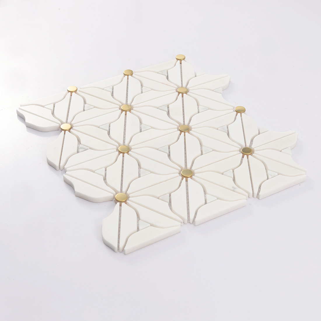 Perspective view of stacked white flower marble mosaic sheets with gold dots