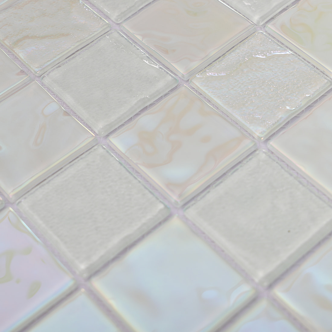 Close-up of white iridescent square glass mosaic tile surface texture