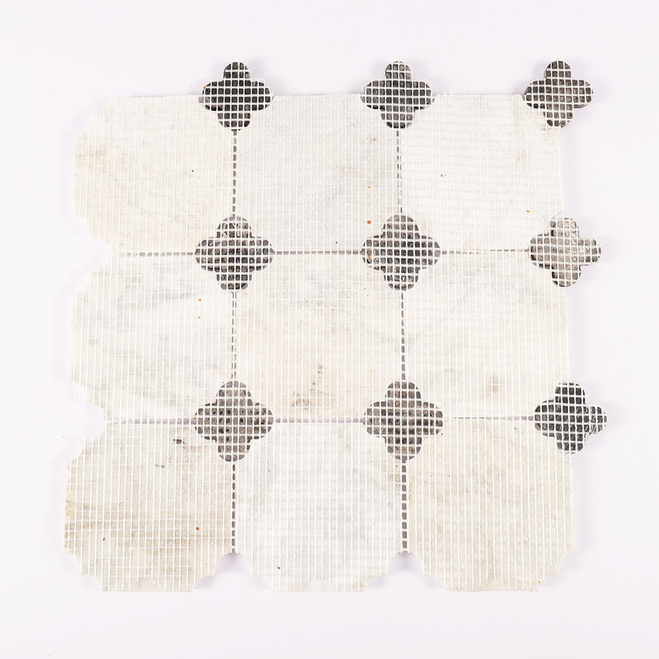 Back mesh view of white marble mosaic tile with black quatrefoil pattern