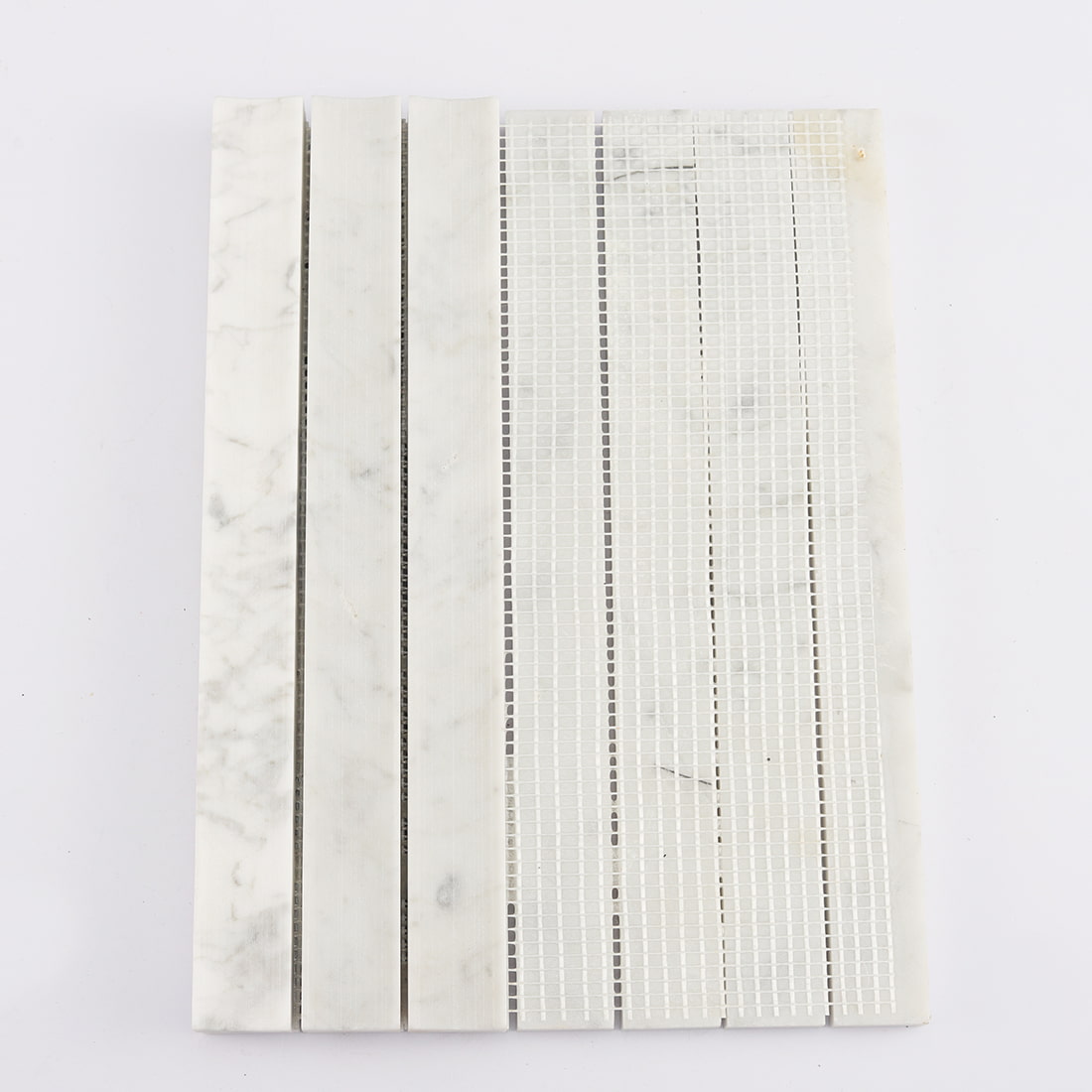 Back view of white marble concave vertical mosaic tile with mesh backing