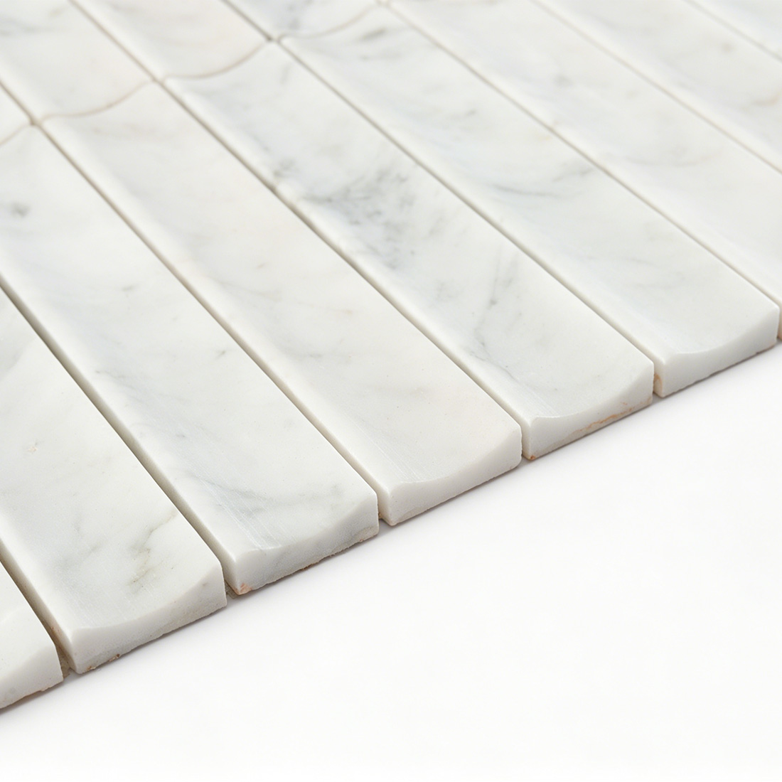 Edge profile of fluted white marble linear tile.