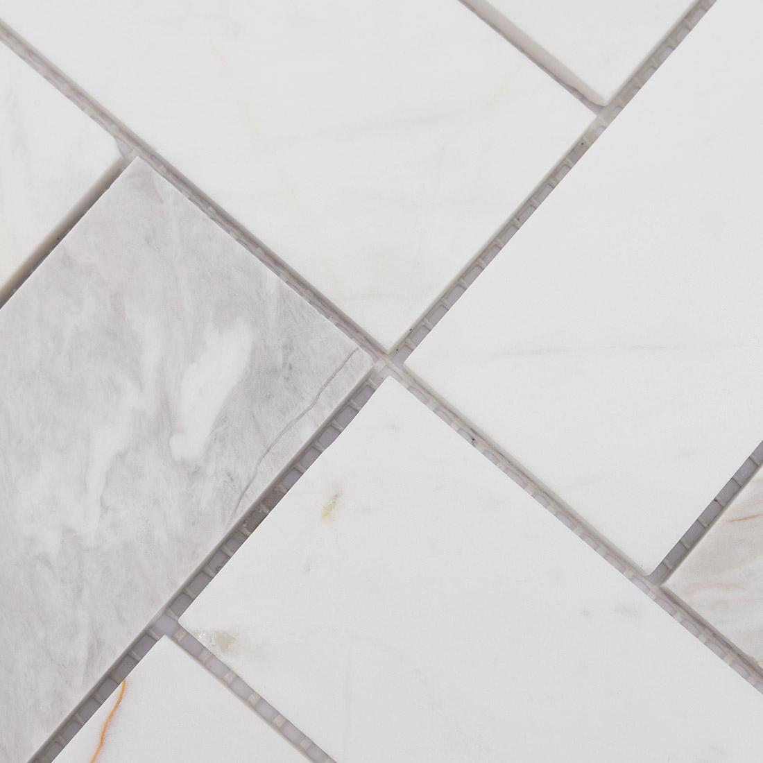 Close-up detail of white and gray veined marble geometric mosaic tile pieces