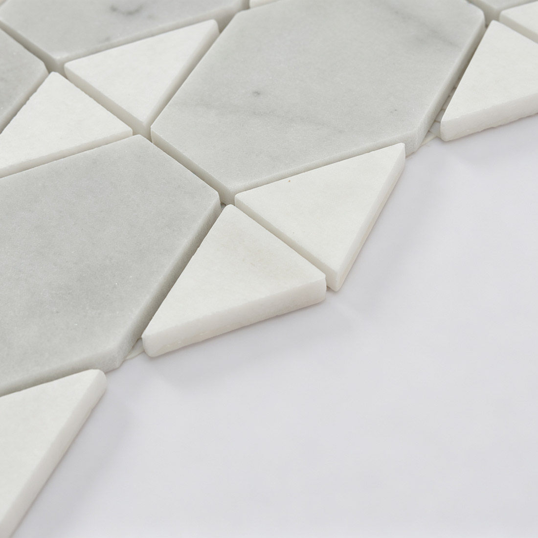 Side view showing the thickness of white marble geometric mosaic tiles