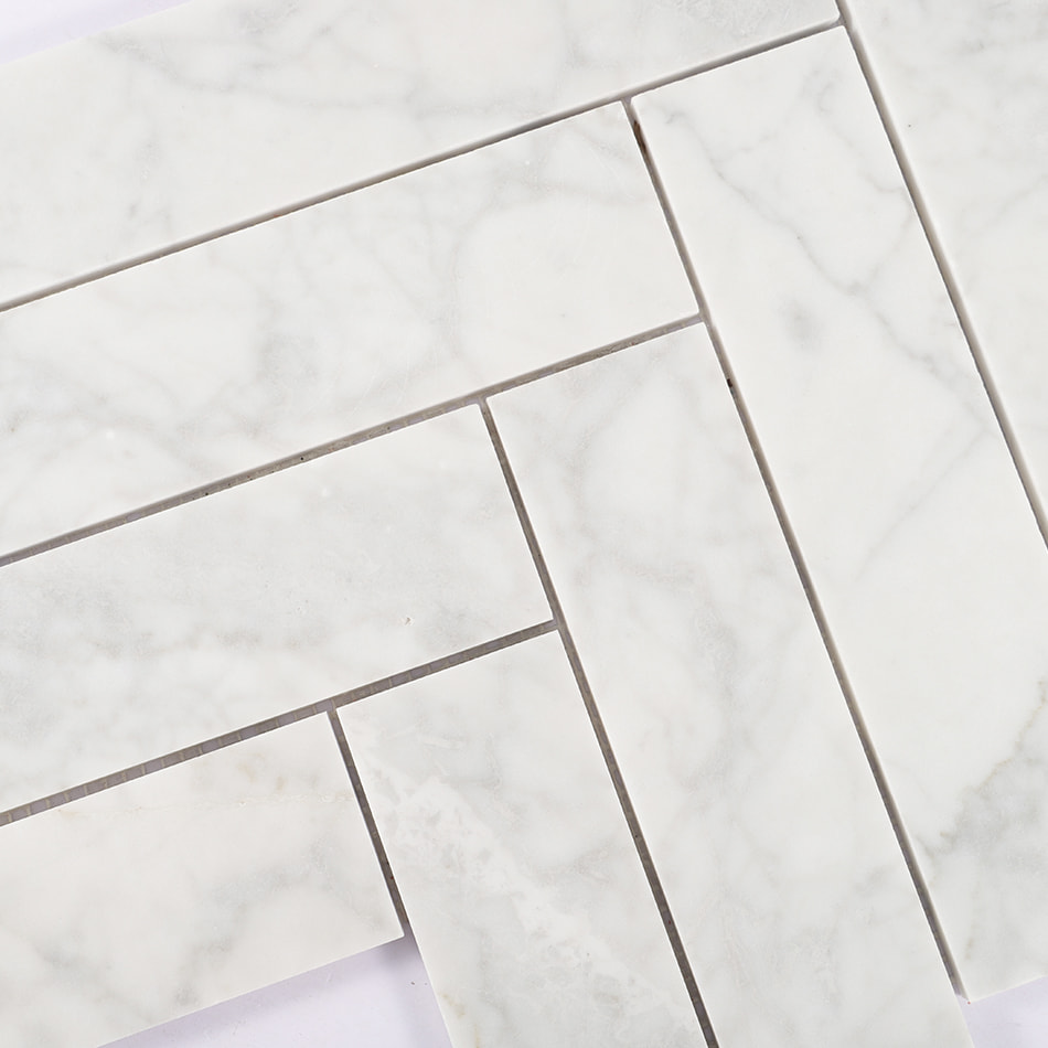Close-up of white marble herringbone mosaic tile pattern