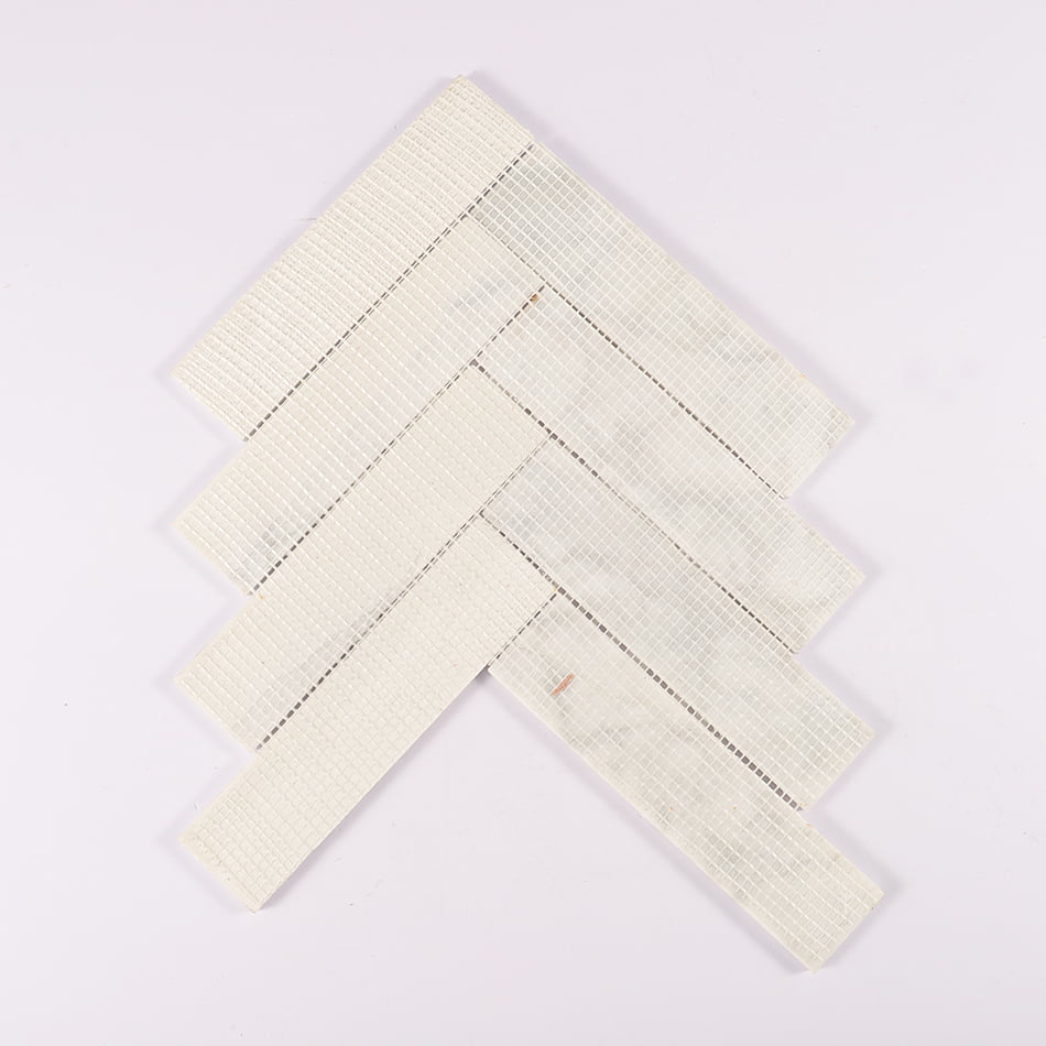 Back view of white marble herringbone mosaic tile with mesh backing