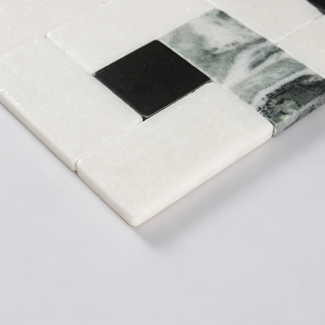 Macro view of white marble strip and black accent tile edge