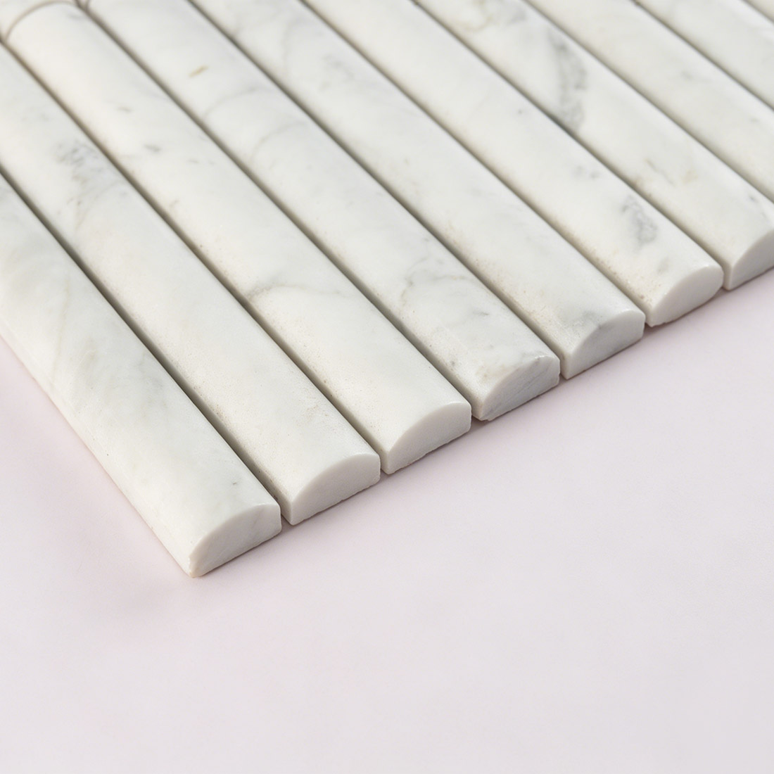 Side profile view highlighting the rod contour of white marble.