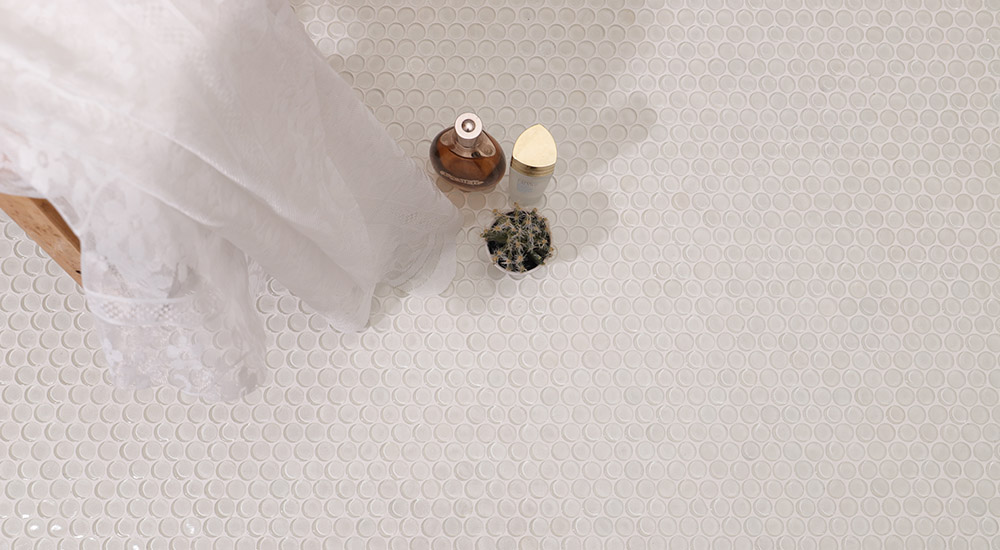 {"default":"White matte penny tiles on a modern bathroom floor with minimalist decor"}
