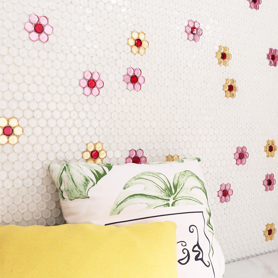 Installed white penny round glass mosaic wall tile with floral pattern accents