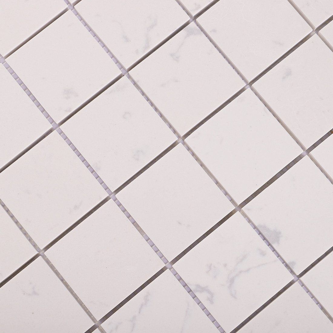 Close-up of white square marble mosaic tile with soft natural marble veins