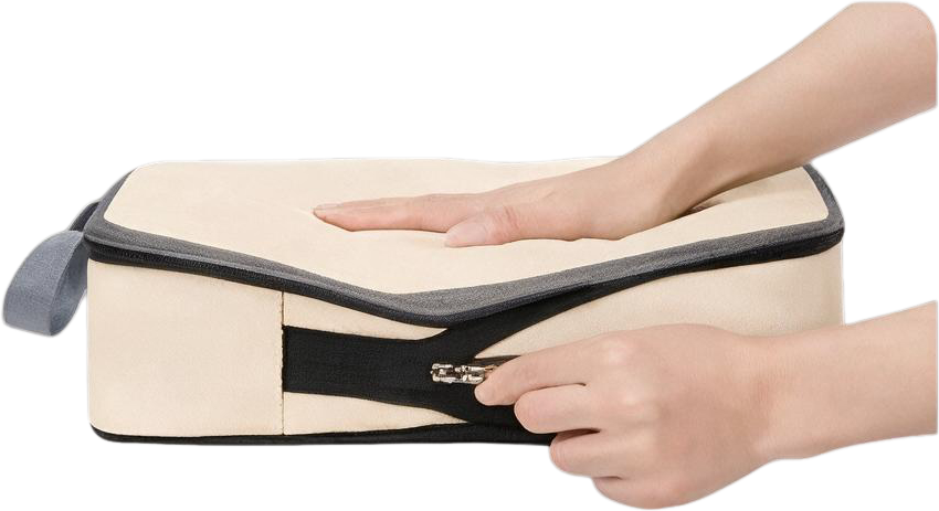 Hand pulling the middle compression zipper to flatten the cube