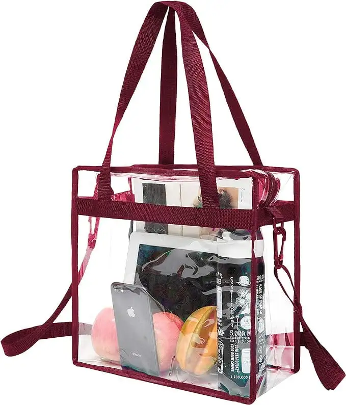 Clear stadium-approved tote bag with zipper, adjustable crossbody strap, and stylish burgundy design.