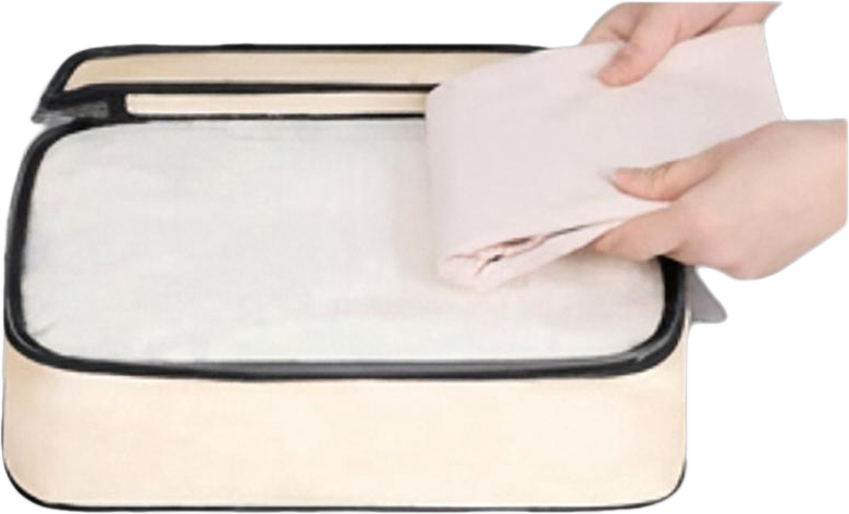 Two hands placing neatly folded clothes into the packing cube