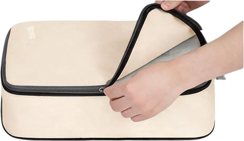 Hands opening a packing cube and placing clothes inside