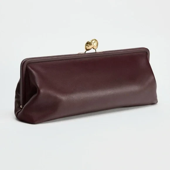 Elongated metal trim leather clutch bag