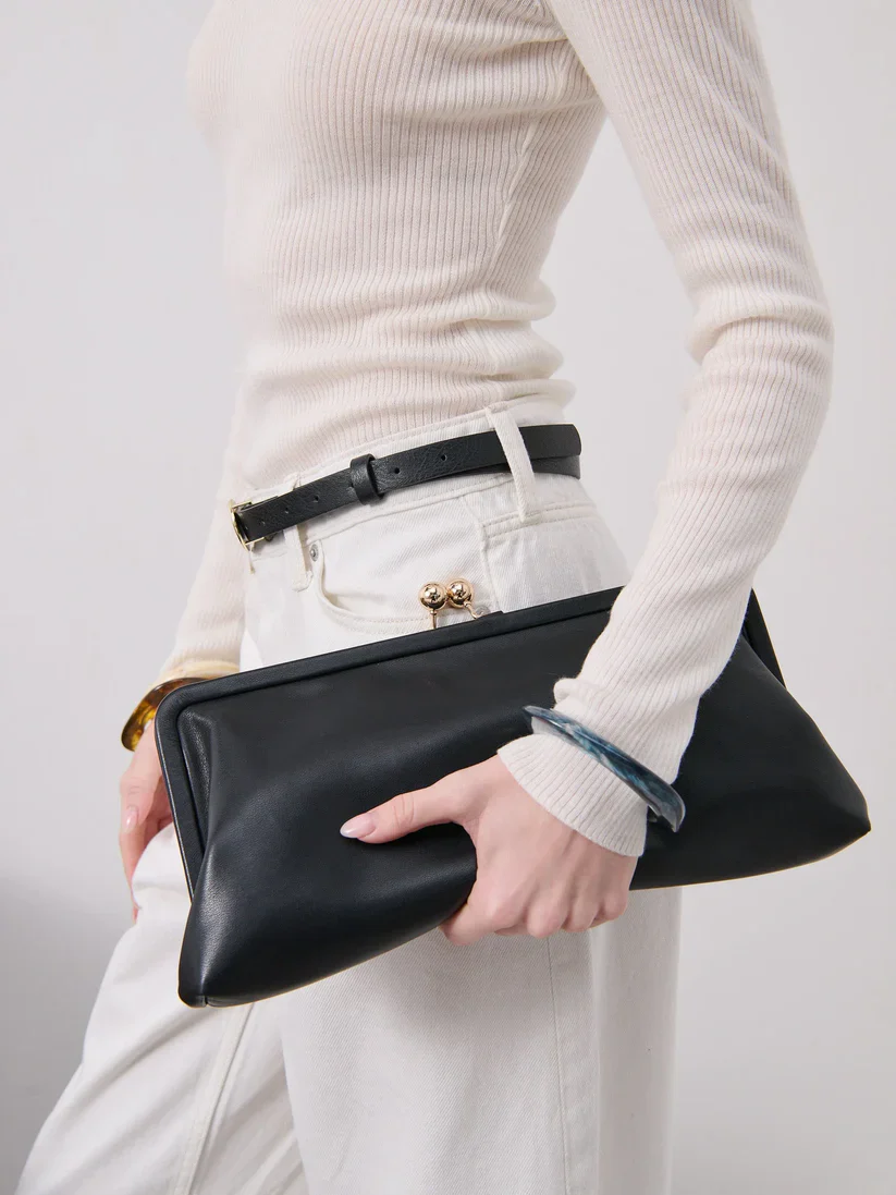 Elongated metal trim leather clutch bag