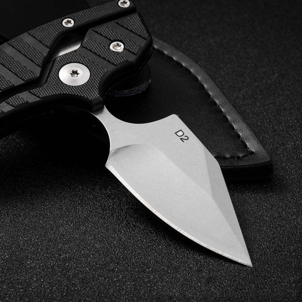 Dragon's Bite Folding knife with black handle and D2 blade on a dark background