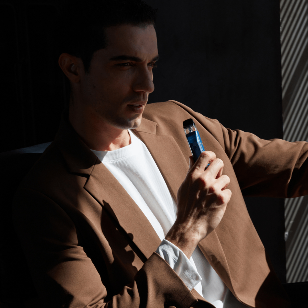 Man in a blazer holding blue Vaporesso XROS Pro vape, RDL pod experience