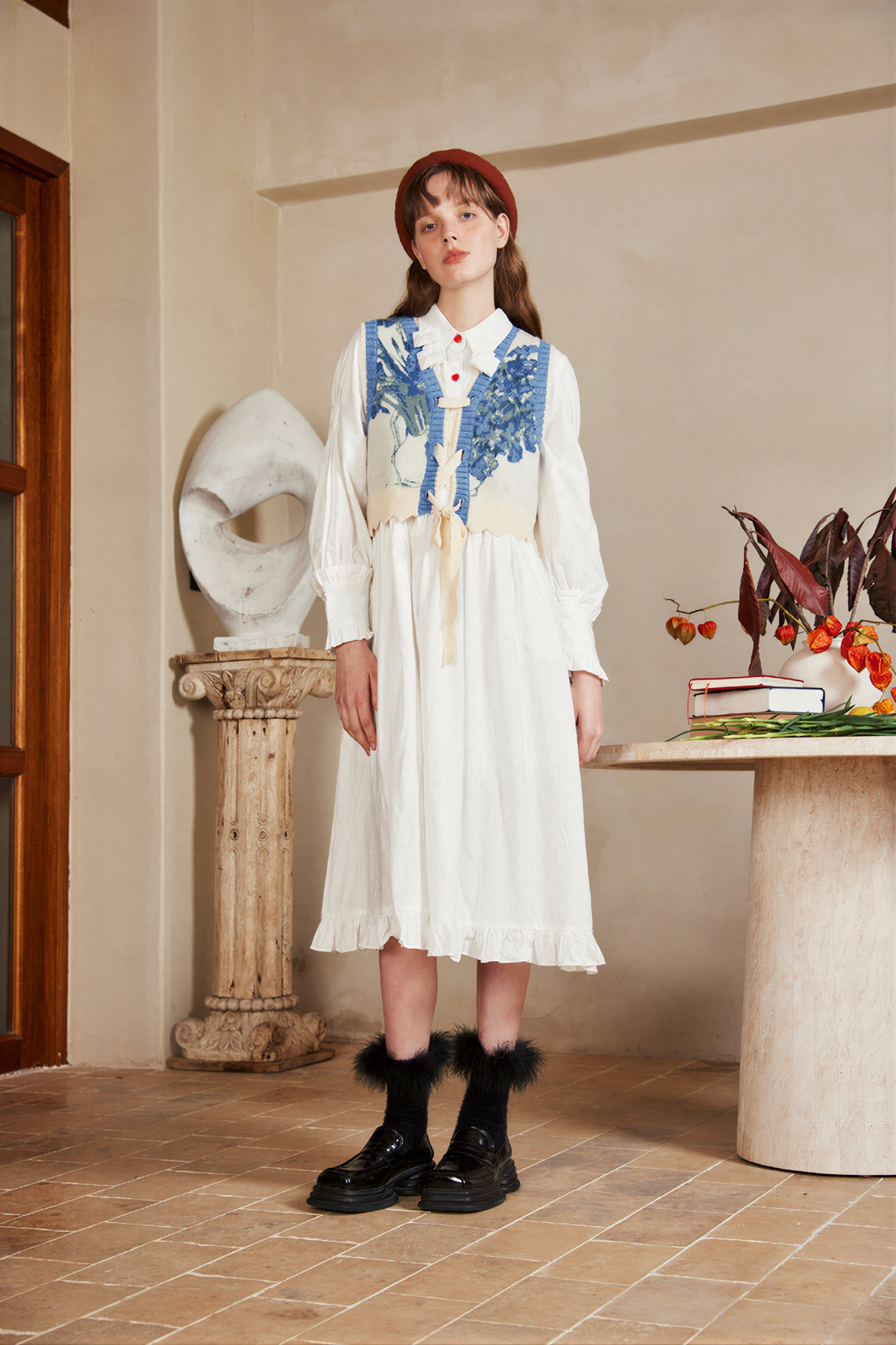 Vintage-style outer layer paired with a knitted sweater