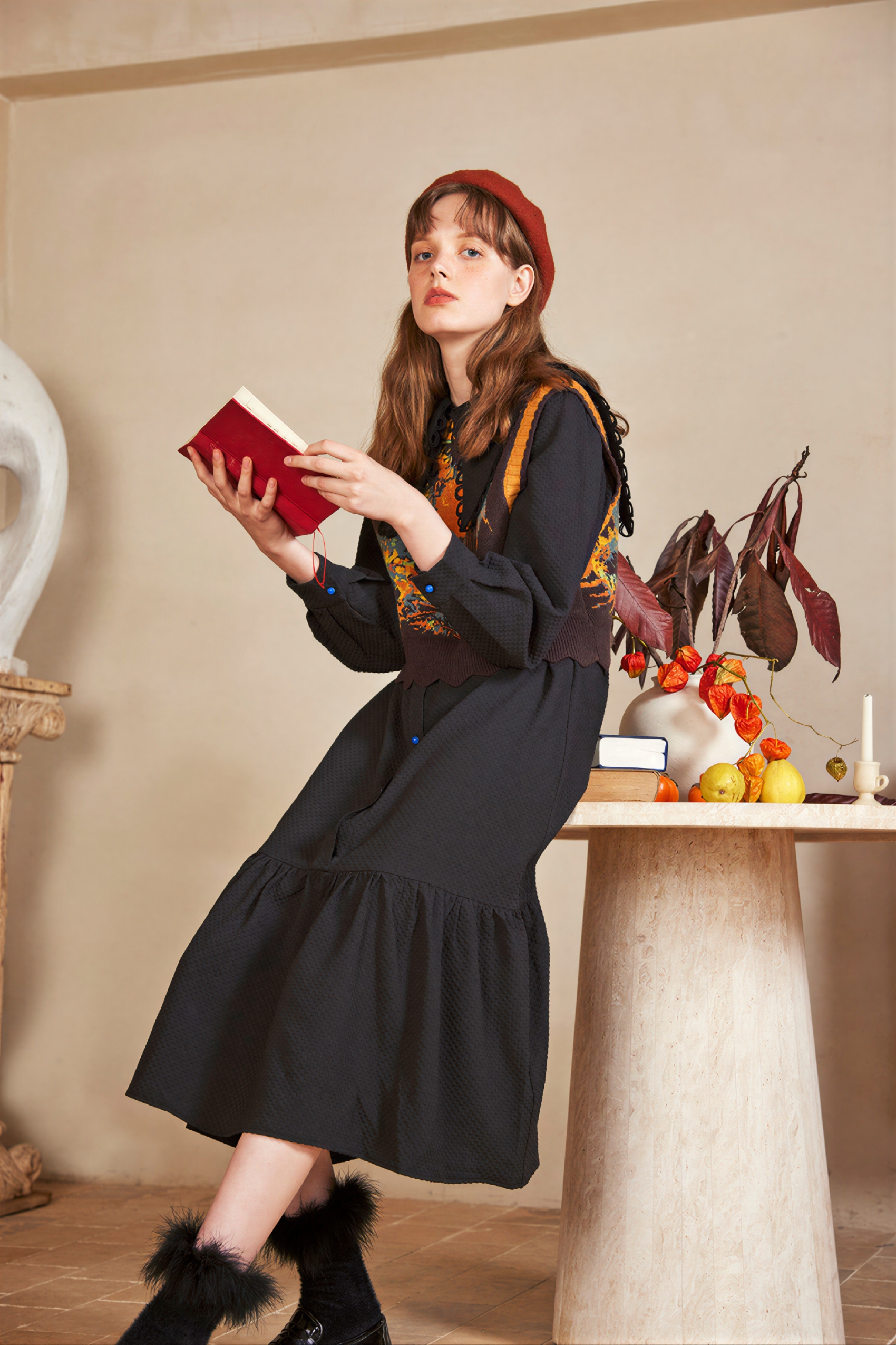 Vintage-style outer layer paired with a knitted sweater