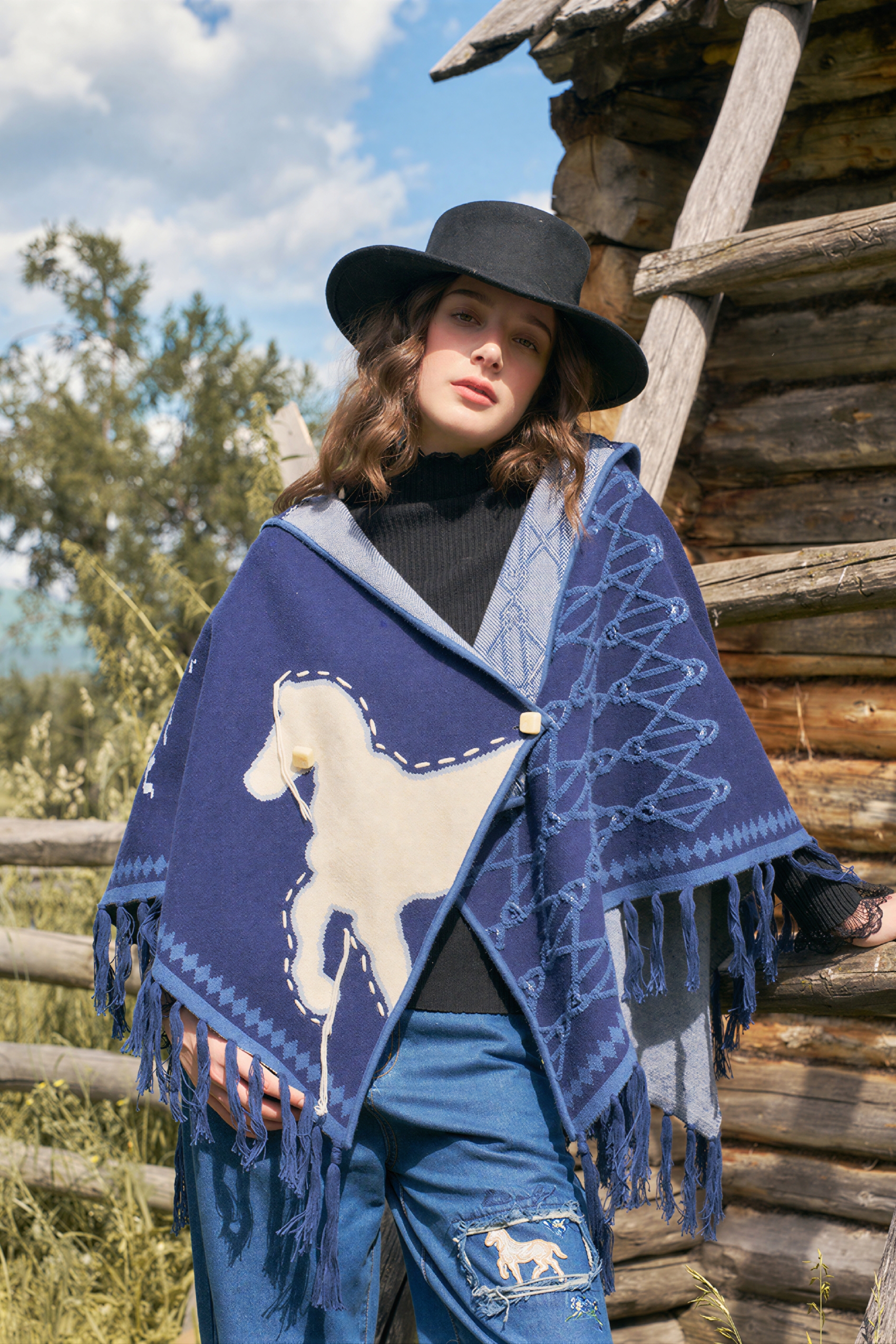 Hooded blue knitted cape