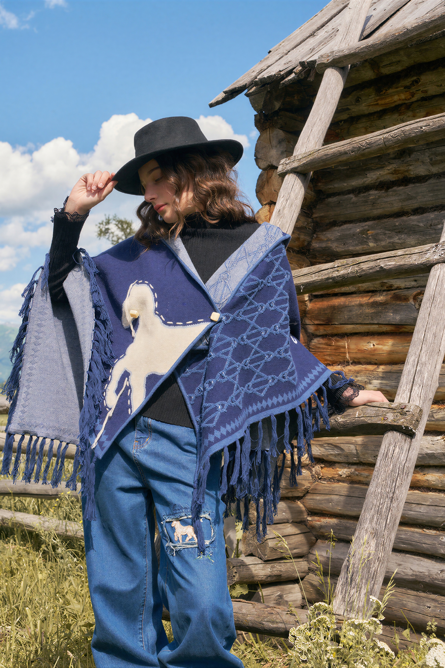 Hooded blue knitted cape